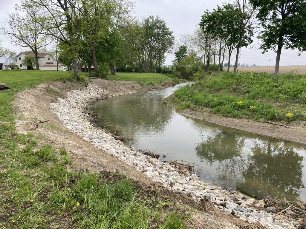 A stream running through a grassy area.